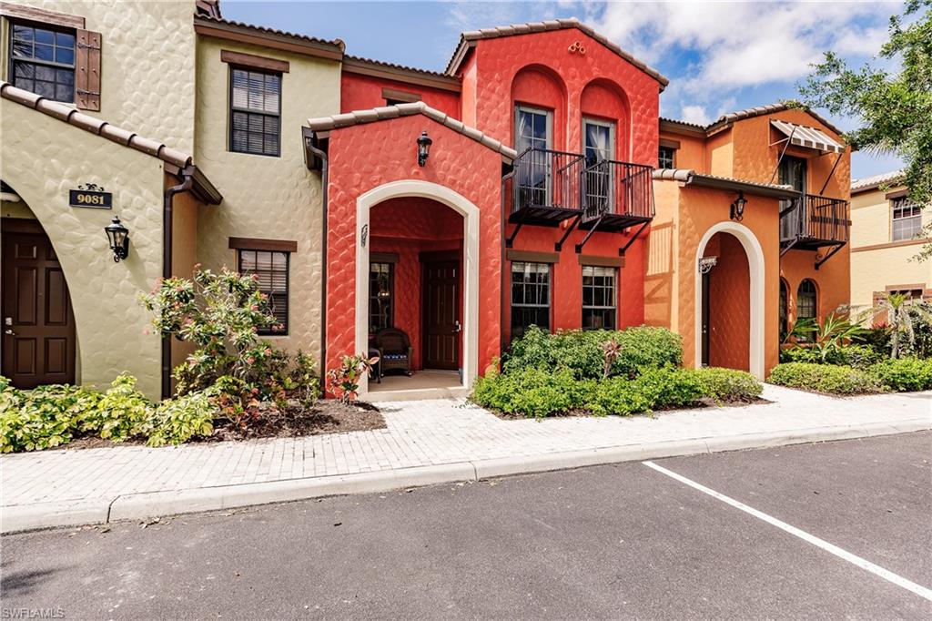 9081 Albion Lane South, Unit 6502 Naples, FL 34113 - Photo 36 of 37 front view of a brick house with a small yard