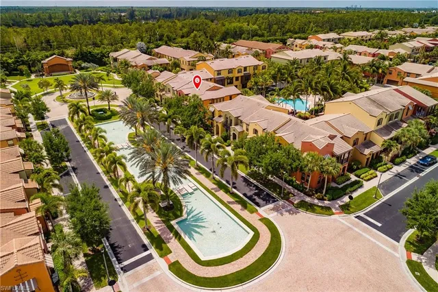 an aerial view of residential houses with outdoor space and swimming pool