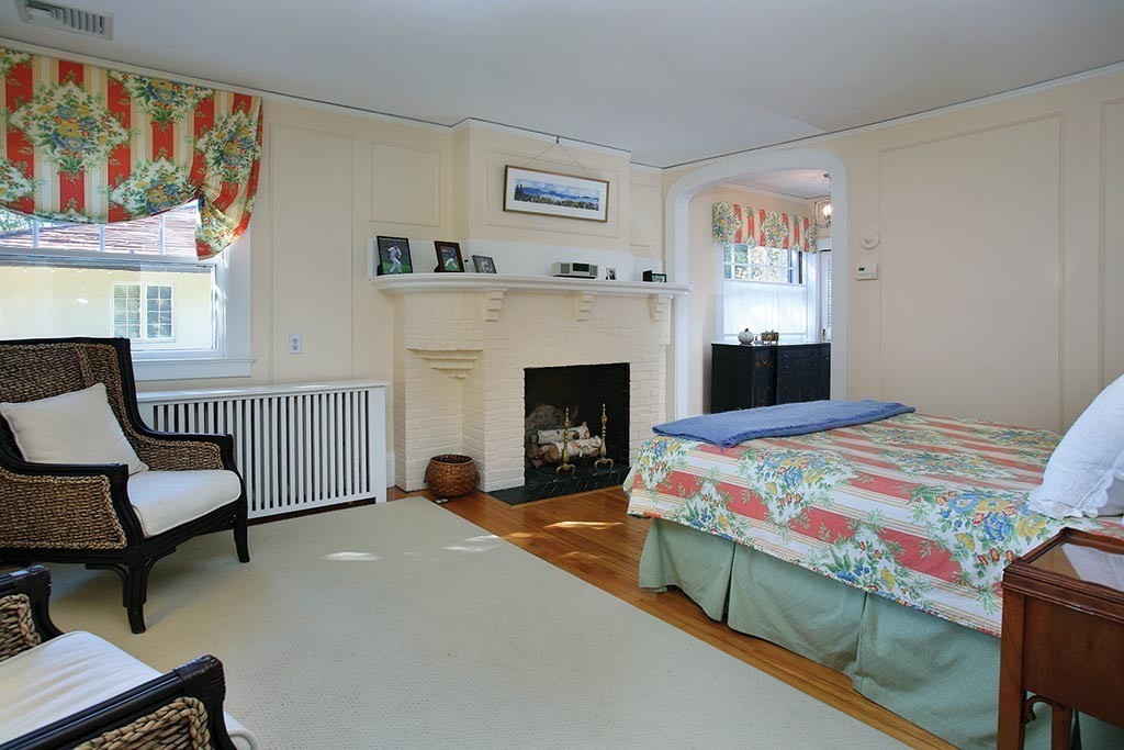 341 Commonwealth Avenue Newton, MA 02467 - Photo 8 of 11 a bedroom with a bed and a fireplace
