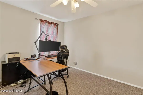 a view of a workspace with furniture and chandelier