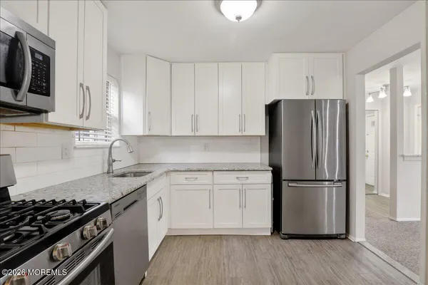 a bedroom with a bed a couch and a television on the table