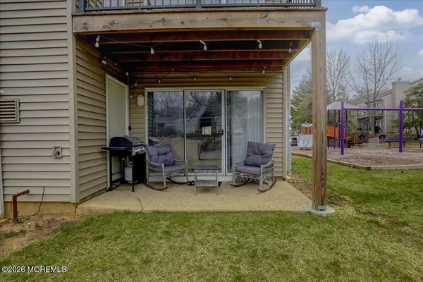 a view of a house with backyard porch and sitting area
