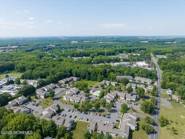 an aerial view of a swimming pool lawn chairs and couches