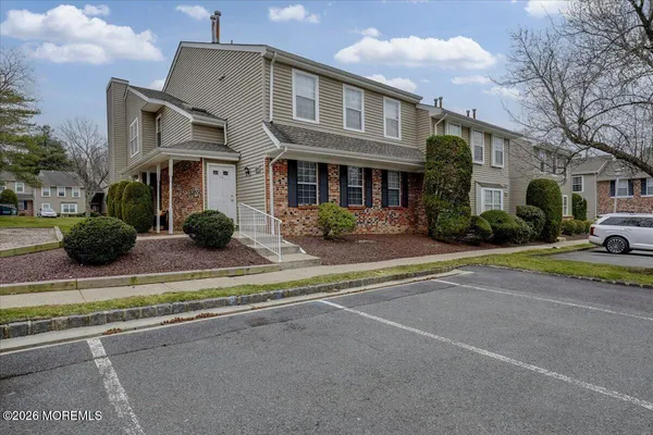 a front view of multiple houses with yard