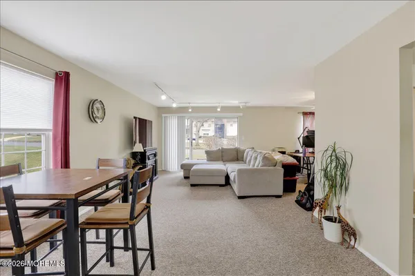 a dining room with furniture and window