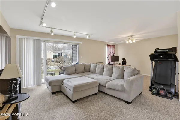 a living room with furniture and a chandelier