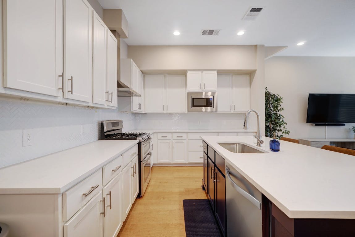 2520 Bluebonnet Lane, Unit 41 Austin, TX 78704 - Photo 11 of 30 a kitchen with stainless steel appliances sink microwave and stove