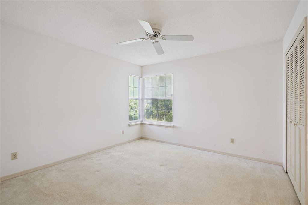 1193 Glen Falls Road DeLand, FL 32720 - Photo 15 of 20 an empty room with a window and a ceiling fan