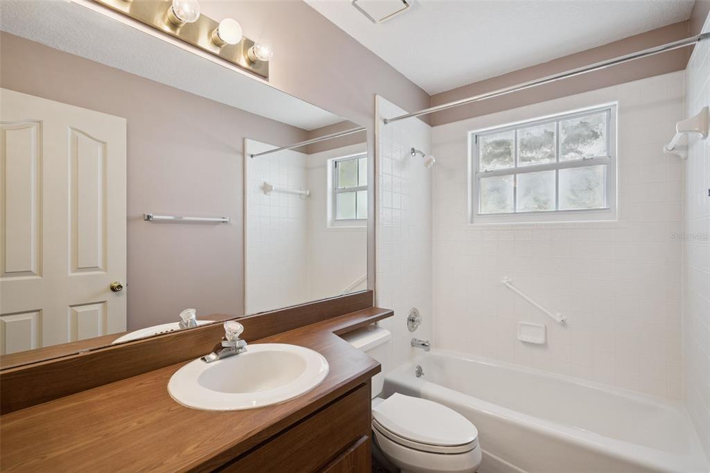 1193 Glen Falls Road DeLand, FL 32720 - Photo 17 of 20 a bathroom with a sink toilet tub and shower