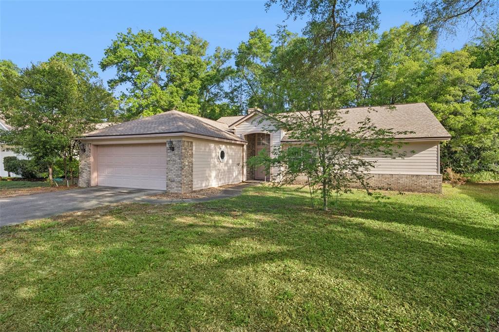 1193 Glen Falls Road DeLand, FL 32720 - Photo 2 of 20 a front view of a house with a garden