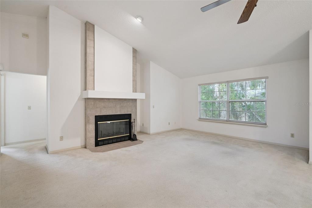 1193 Glen Falls Road DeLand, FL 32720 - Photo 3 of 20 an empty room with fireplace and window