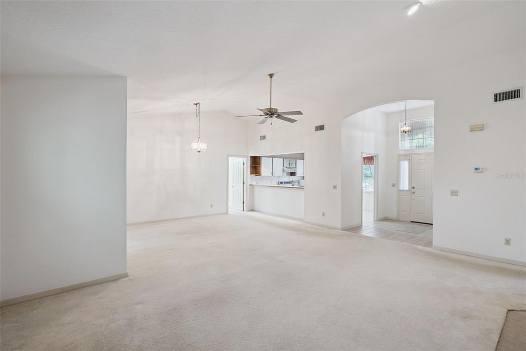 1193 Glen Falls Road DeLand, FL 32720 - Photo 7 of 20 a view of a big room with chandelier fan and windows