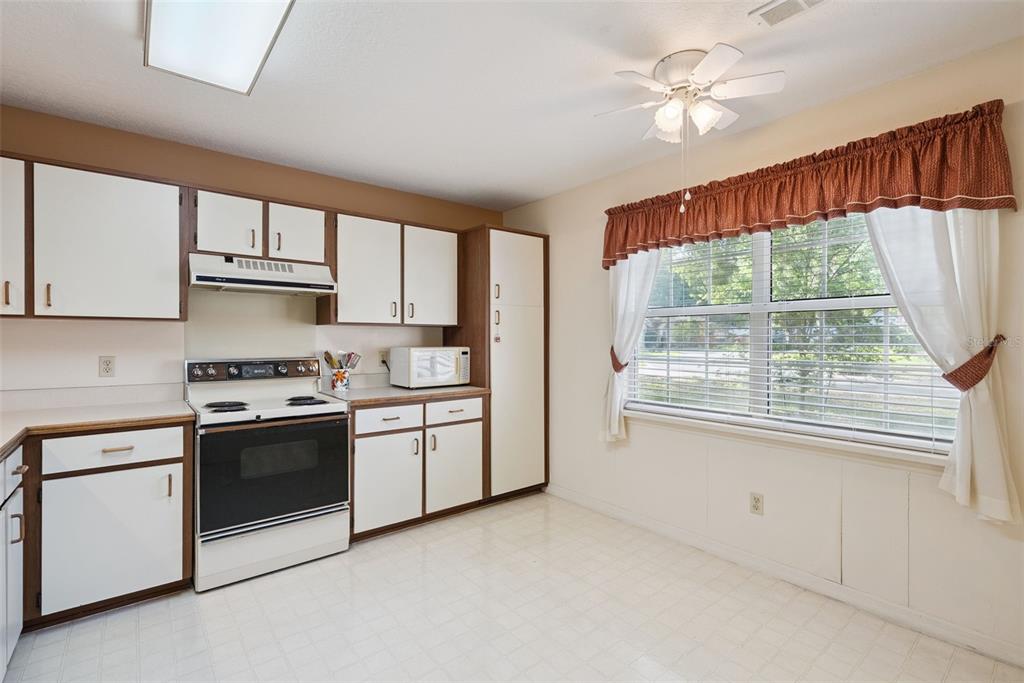 1193 Glen Falls Road DeLand, FL 32720 - Photo 10 of 20 a kitchen with stainless steel appliances granite countertop a stove a sink and a refrigerator
