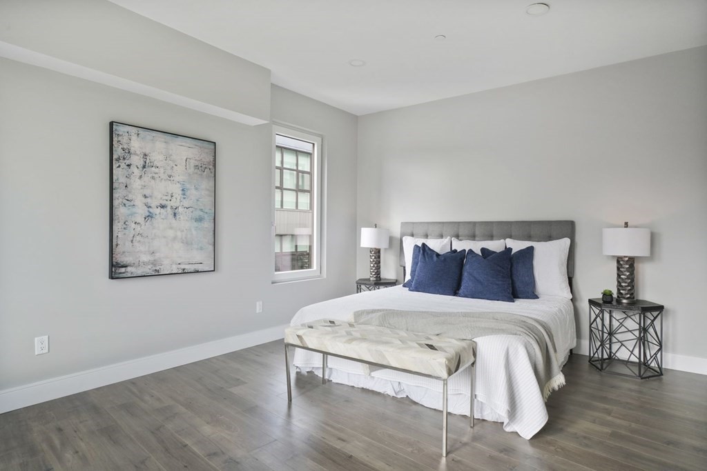 610 Rutherford Avenue, Unit 306 Boston, MA 02129 - Photo 5 of 10 a bedroom with a bed and wooden floor