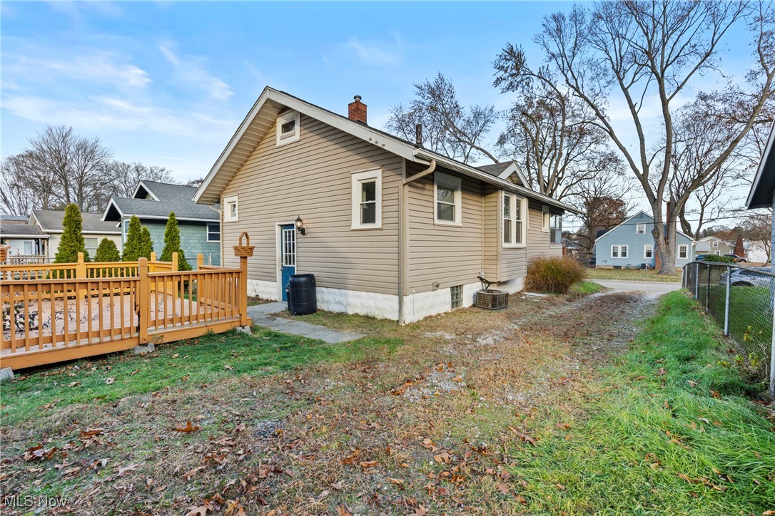 640 Plainfield Road Akron, OH 44312 - Photo 23 of 25 Rear view of property featuring a wooden deck and a chimney