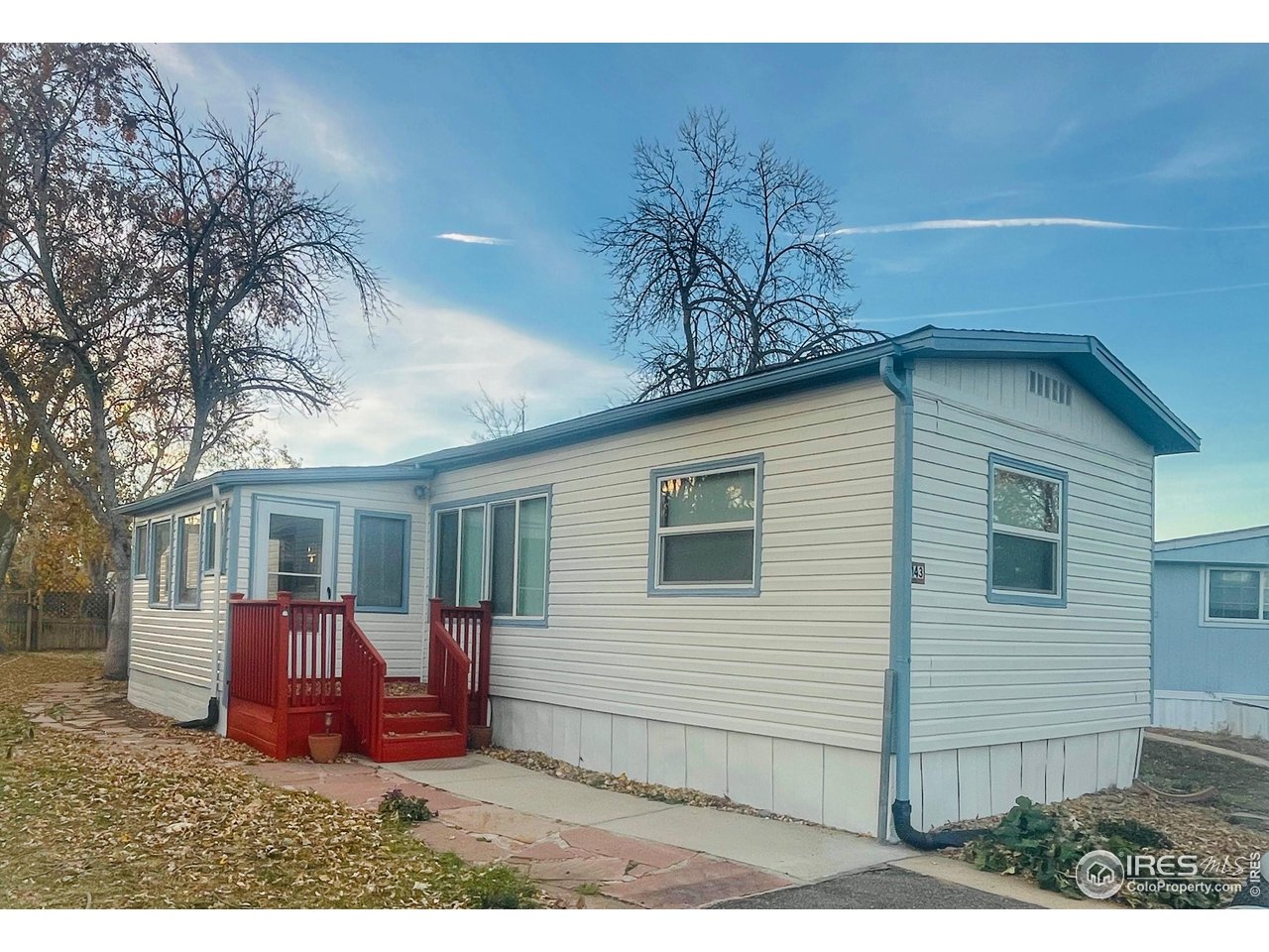 a view of a house with a yard chairs and a table