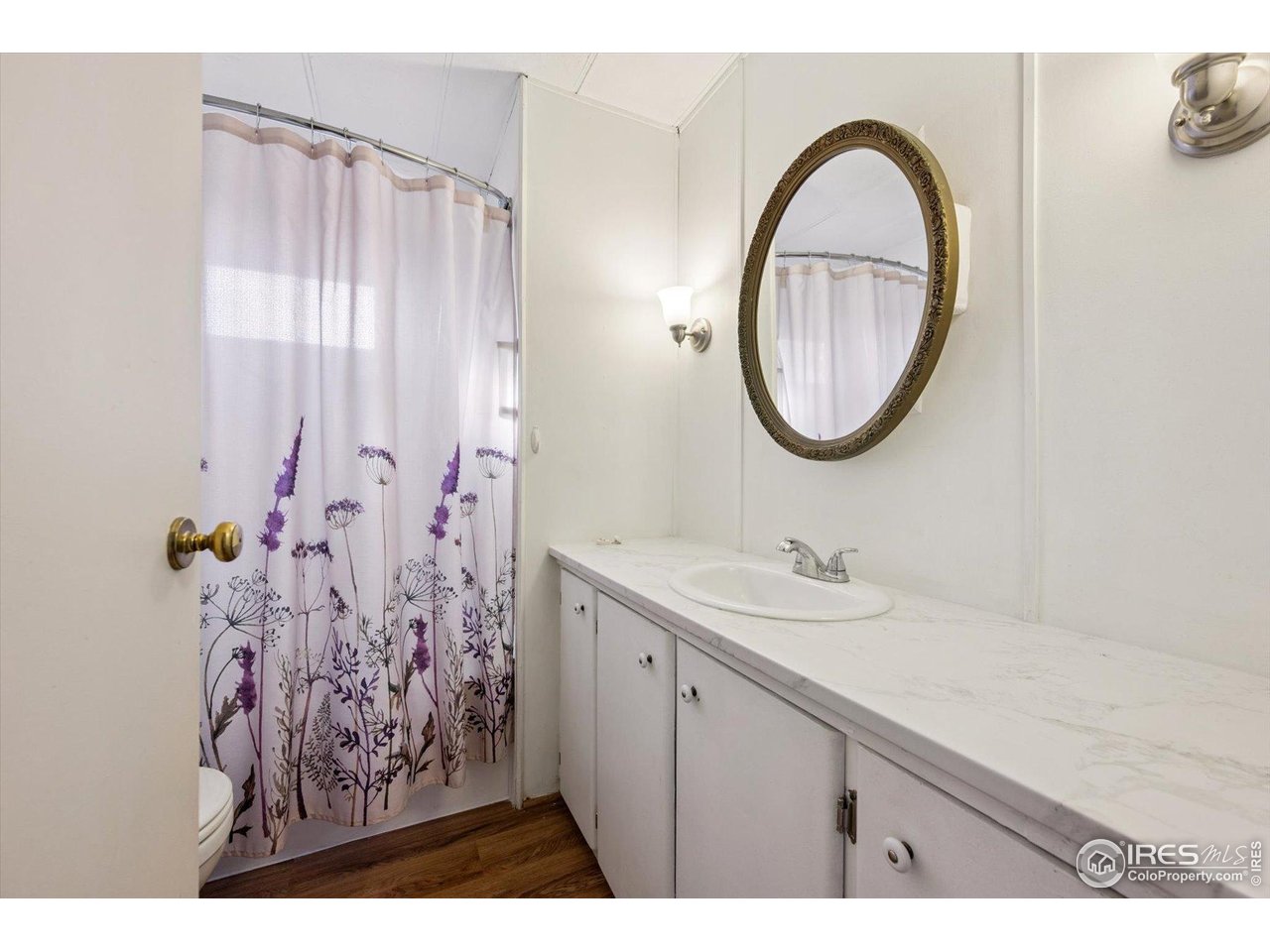 11990 East South Boulder Road, Unit 143 Lafayette, CO 80026 - Photo 14 of 19 a bathroom with a sink and a mirror