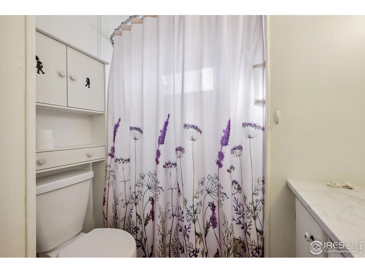 11990 East South Boulder Road, Unit 143 Lafayette, CO 80026 - Photo 15 of 19 a bathroom with a sink and a shower curtain