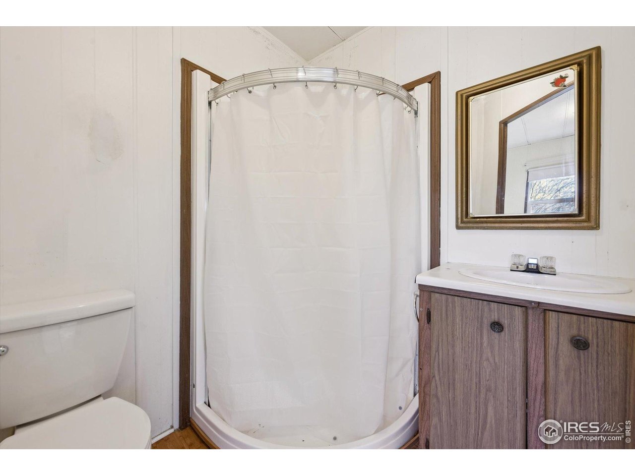 11990 East South Boulder Road, Unit 143 Lafayette, CO 80026 - Photo 19 of 19 a bathroom with a sink a toilet and mirror