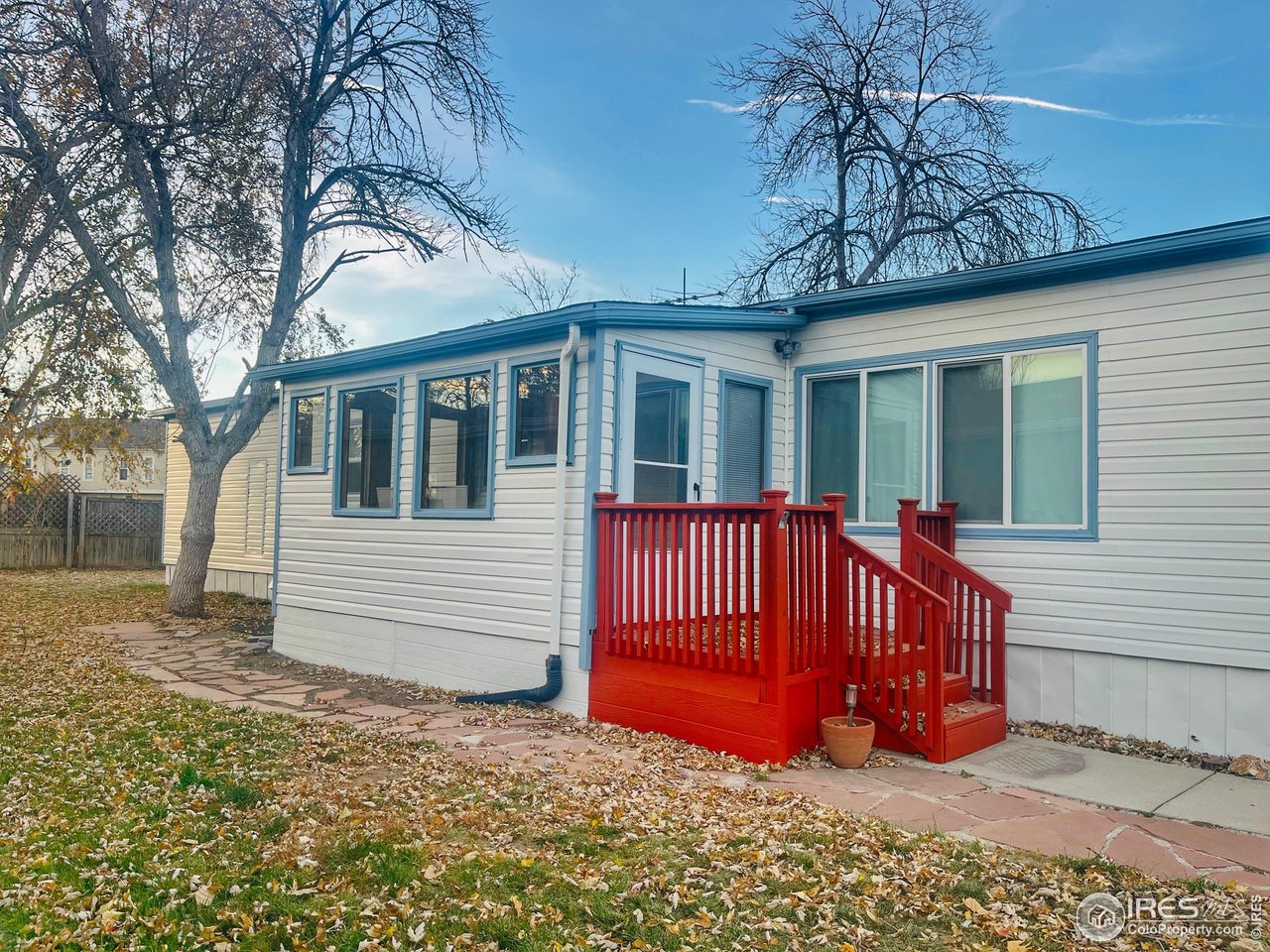 11990 East South Boulder Road, Unit 143 Lafayette, CO 80026 - Photo 3 of 19 a view of a house with a bed and wooden fence