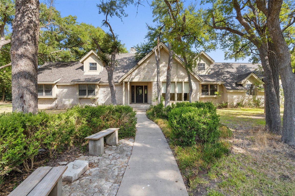 a front view of a house with garden