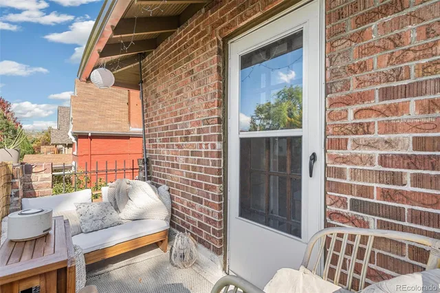 a view of a door and chair in the balcony