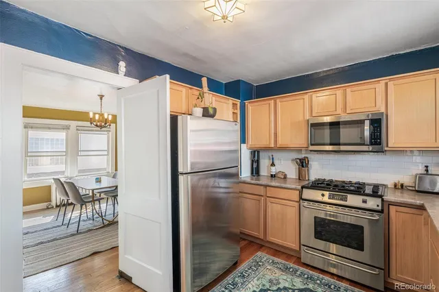 a kitchen with stainless steel appliances a refrigerator stove and microwave