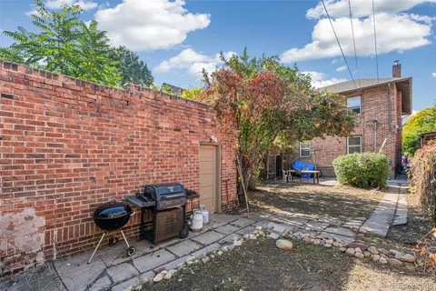 a view of a chairs and table in backyard