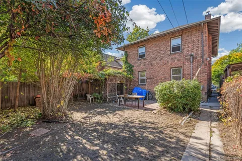 a backyard of a house with outdoor seating
