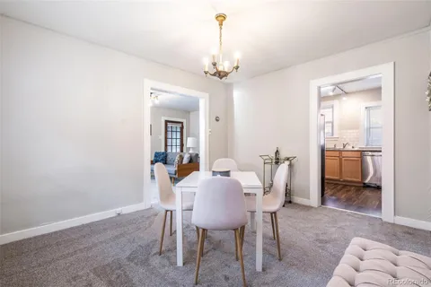 a view of a dining room with furniture and a chandelier