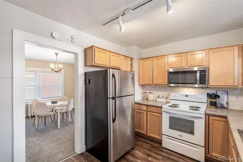 a kitchen with a refrigerator a stove top oven a sink and dishwasher