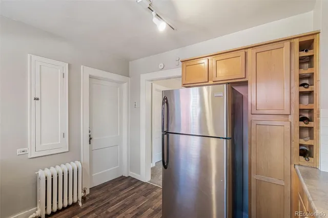 a view of a refrigerator in kitchen and wooden floor