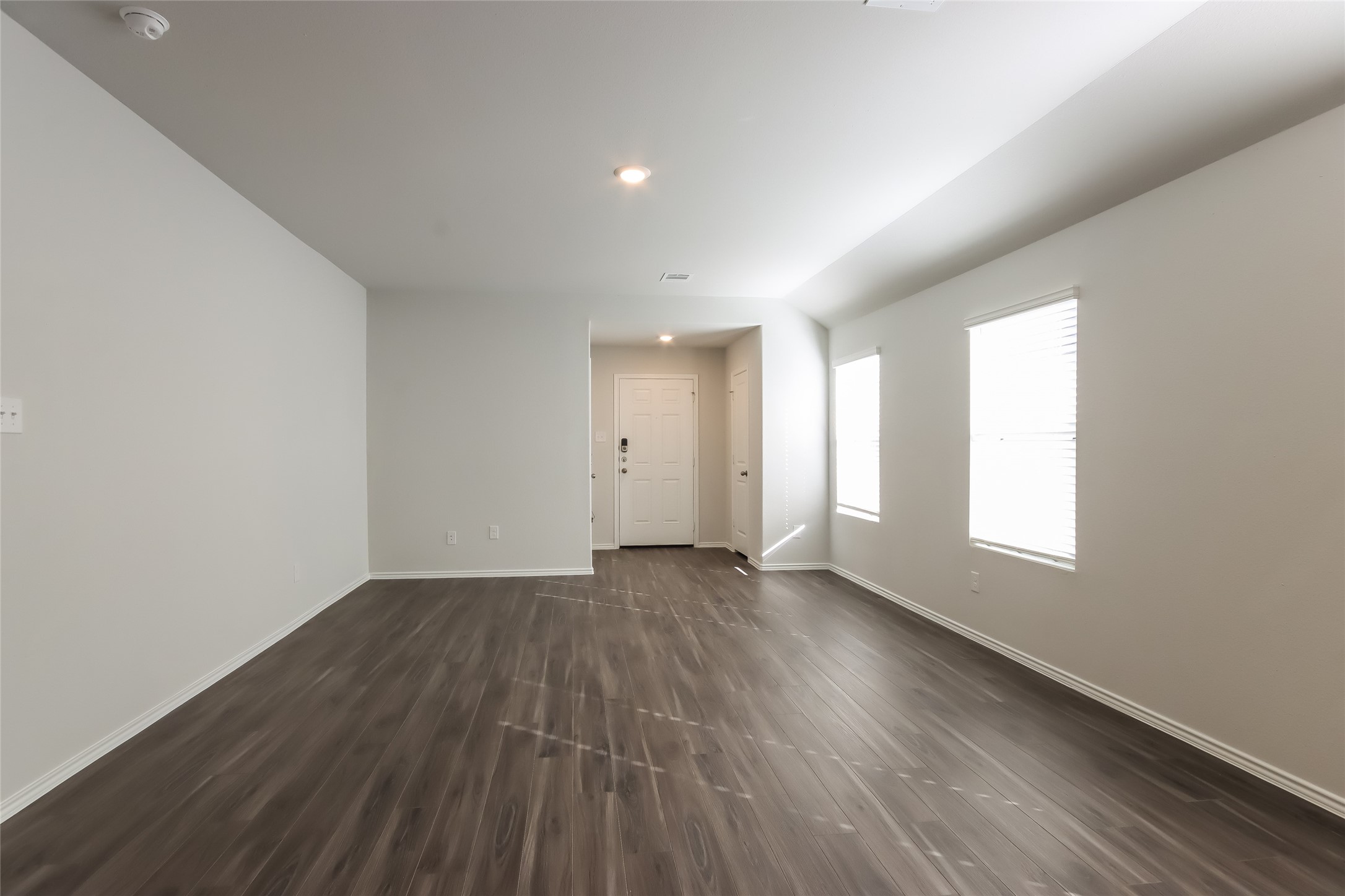 22304 Merlin Street Splendora, TX 77372 - Photo 2 of 14 an empty room with wooden floor and windows