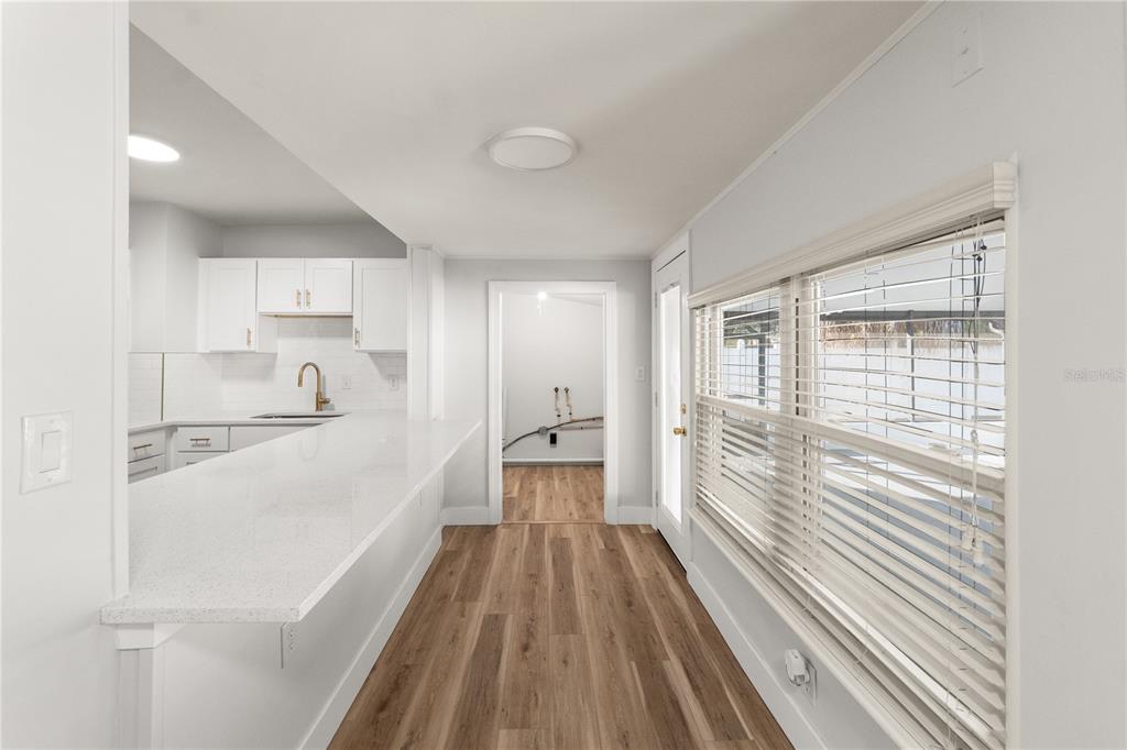 2213 West Ohio Avenue Tampa, FL 33607 - Photo 17 of 21 a hallway with white cabinets and wooden floor
