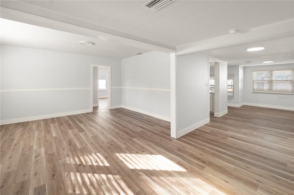 2213 West Ohio Avenue Tampa, FL 33607 - Photo 4 of 21 wooden floor in an empty room with a window