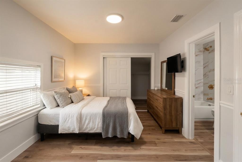 2213 West Ohio Avenue Tampa, FL 33607 - Photo 7 of 21 a bedroom with a bed and a flat screen tv