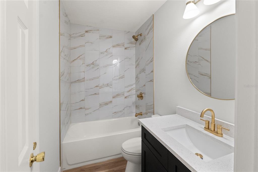 2213 West Ohio Avenue Tampa, FL 33607 - Photo 10 of 21 a bathroom with a sink a toilet and a mirror