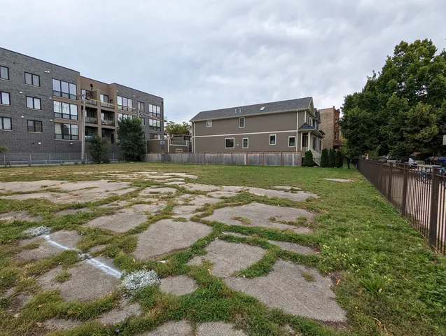 a view of house with backyard and tree