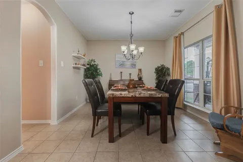 a dining room with furniture a chandelier and a rug