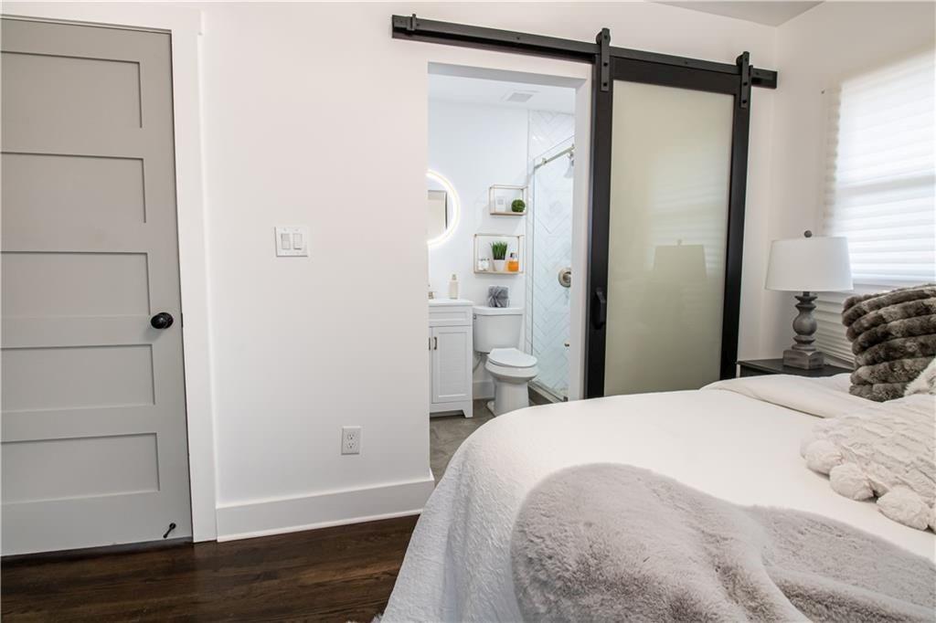 3548 Glensford Drive Decatur, GA 30032 - Photo 21 of 47 a bedroom with a bed and wooden floor