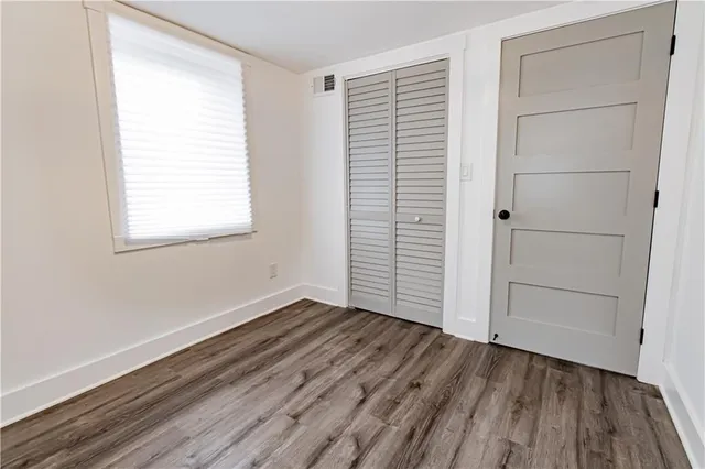 a view of a room with wooden floor
