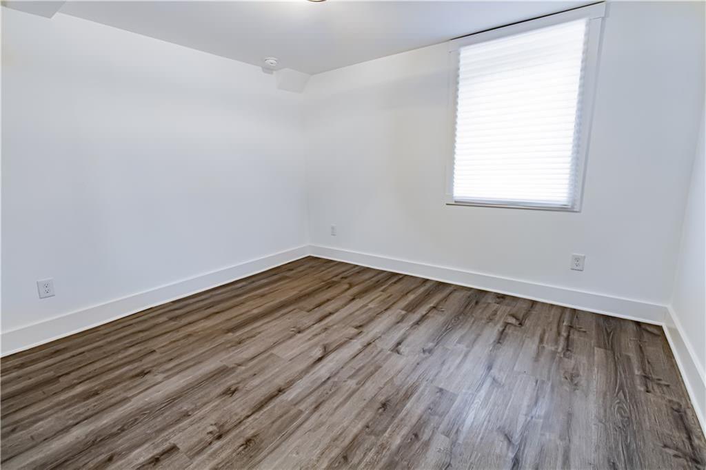3548 Glensford Drive Decatur, GA 30032 - Photo 33 of 47 an empty room with wooden floor and windows