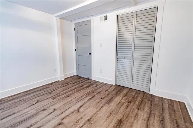 a view of a room with wooden floor