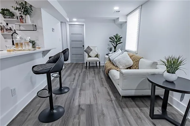 a living room with furniture and a wooden floor