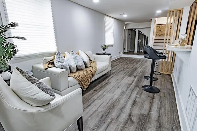 a view of a hallway with wooden floor and staircase