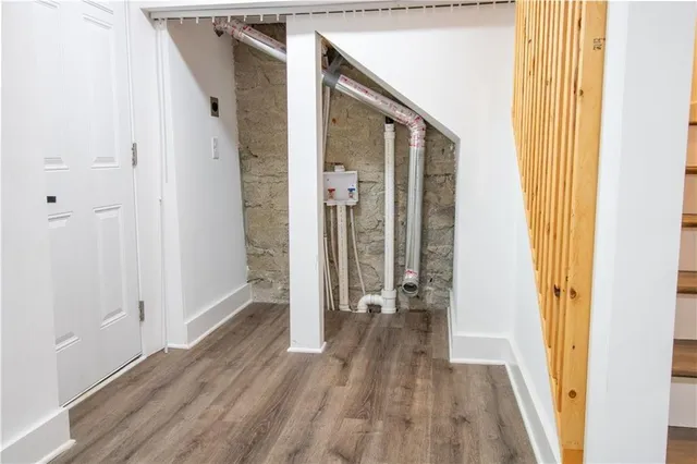a view of a kitchen with wooden floor and electronic appliances