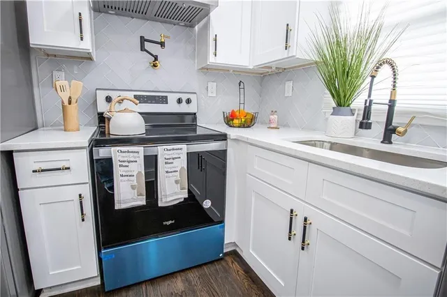 a kitchen with appliances and cabinets