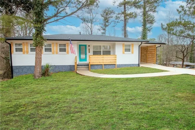 a house view with a sitting space and garden