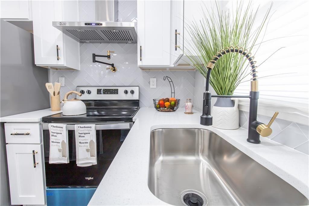 3548 Glensford Drive Decatur, GA 30032 - Photo 5 of 47 a kitchen with a sink a counter appliances and cabinets