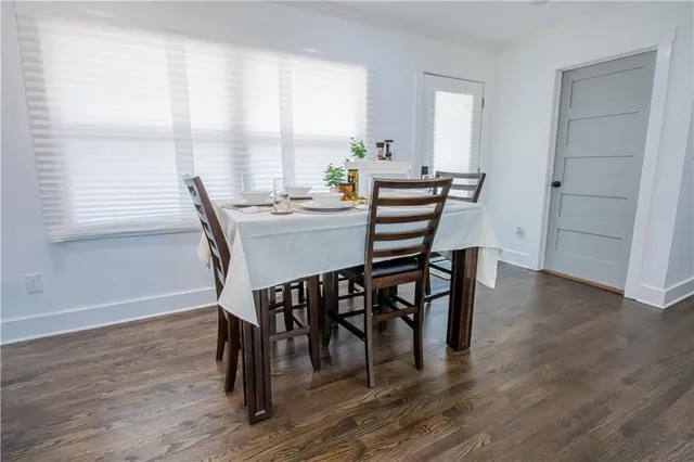 a view of a dining room with furniture and wooden floor